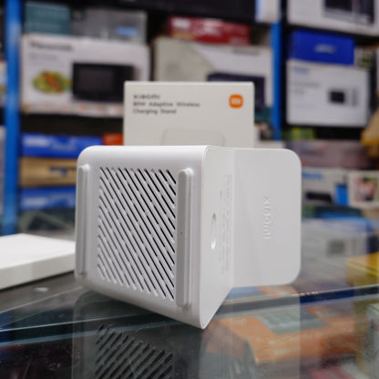 White electronic device with mesh design on top, displayed in a store setting.