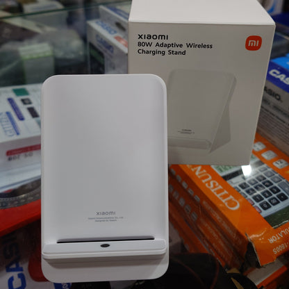 White electronic device on a box with brand names in the background
